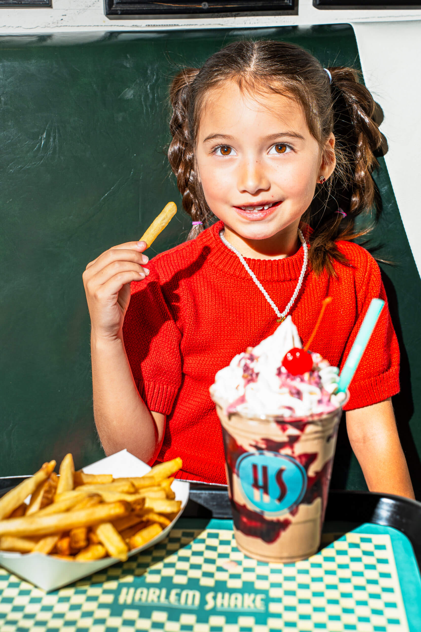 little girl with shake and fries